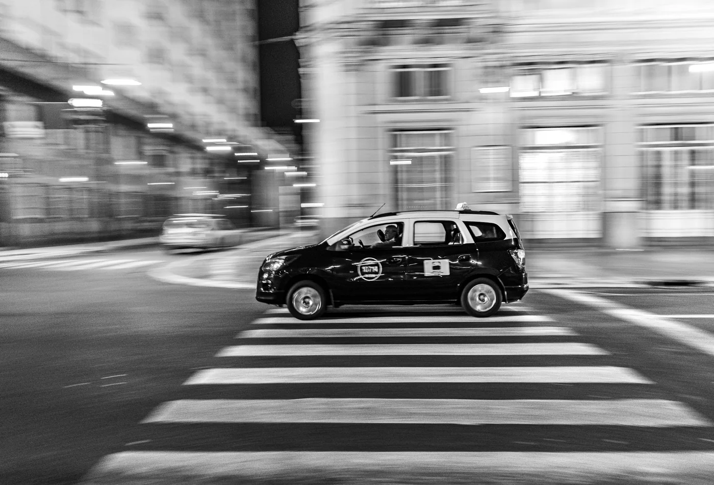 A taxi crossing a Buenos Aires street at night, motion-blurred (representative photograph, not a Señor Tango transfer vehicle)